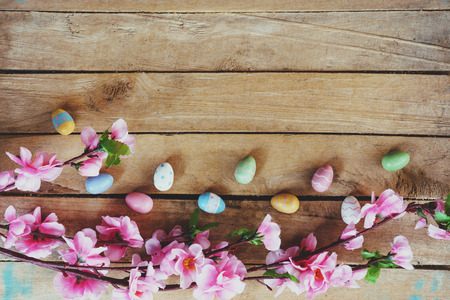 Cherry blossom Artificial flowers and easter egg on vintage wooden background with copy space.の写真素材