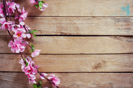 Cherry blossom and Artificial flowers on vintage wooden background with copy space.の写真素材