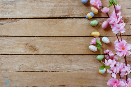 Cherry blossom Artificial flowers and easter egg on vintage wooden background with copy space.の写真素材