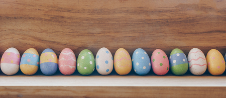 colorful easter eggs on wooden background with copy space.の写真素材