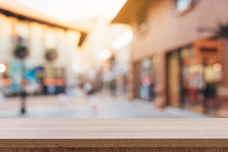 Empty wood table and Vintage tone blurred defocused of crowd people in walking street festival and shopping mall.の写真素材