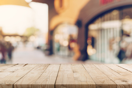 Empty wood table and Vintage tone blurred defocused of crowd people in walking street festival and shopping mall.の写真素材