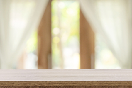 Empty wooden table and blur window background with copy space, display montage for product.の写真素材