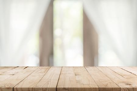 Empty wooden table and blur window background with copy space, display montage for product.の写真素材