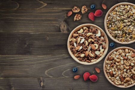 bowl of granola for breakfast with fresh berries, strawberry on wood with copy space.の写真素材