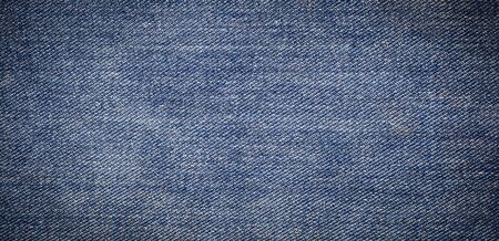 panorama of old blue jeans background and textureの写真素材