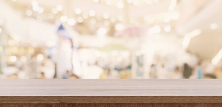 Empty wood table and blurred light table in shopping mall with bokeh background. product display template.の写真素材