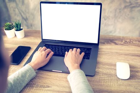 asian woman using laptop computer do online activity on wood table at home office.の写真素材