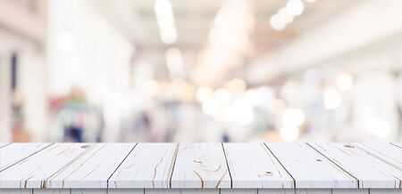 Empty wood table and blurred light table in shopping mall with bokeh background. product display template.の写真素材