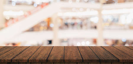 Empty wood table and blurred light table in shopping mall with bokeh background. product display template.の写真素材