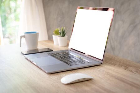 Laptop computer with blank screen on table.の写真素材