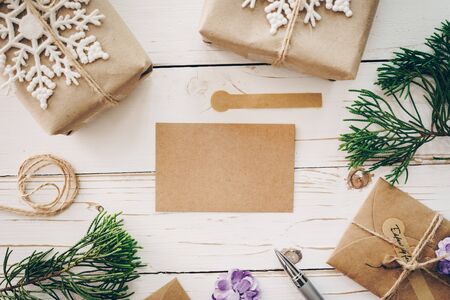 Top view of empty christmas card on wooden table with xmas decoration.の写真素材