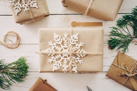 Top view of gift box and christmas card on wooden table with xmas decoration.の写真素材