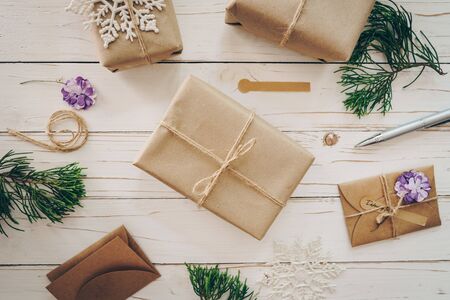 Top view of gift box and christmas card on wooden table with xmas decoration.の写真素材