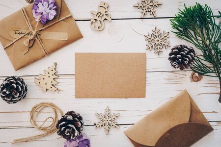 Top view of empty christmas card on wooden table with xmas decoration.の写真素材