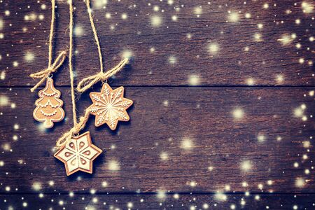 Christmas decoration hanging on snow wood background with copyspace.の写真素材