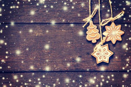 Christmas decoration hanging on snow wood background with copyspace.の写真素材