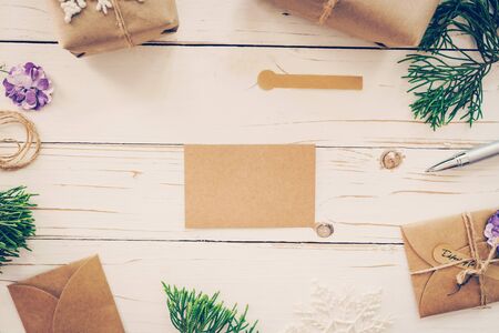 Top view of empty christmas card on wooden table with xmas decoration.の写真素材