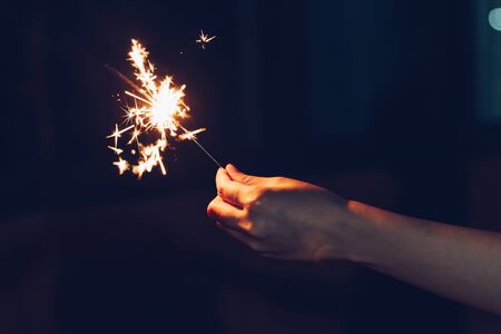 Close up hand woman holding sparklers in night party and christmas celebration.の写真素材