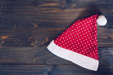Santa claus hat on wood background with copy spaceの写真素材