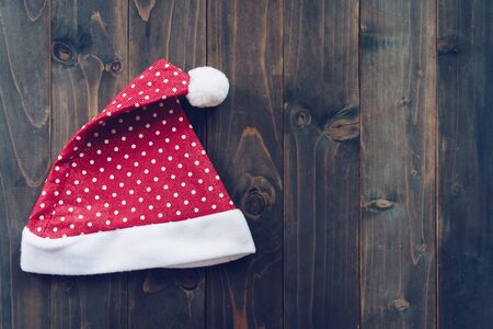 Santa claus hat on wood background with copy spaceの写真素材