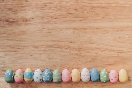 Colorful easter eggs on wooden table background vintage with copy space.の写真素材