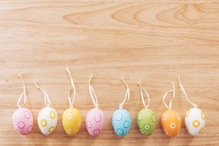 Colorful easter eggs on wooden table background vintage with copy space.の写真素材