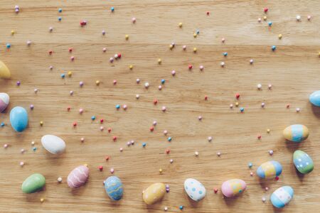 Easter eggs on on wood background top view with natural light. Flat lay style.の写真素材