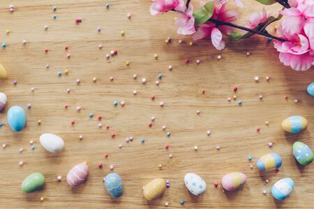 Easter eggs on on wood background top view with natural light. Flat lay style.の写真素材