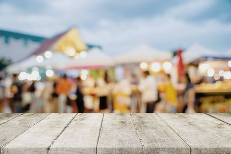 Empty wood table and blurred light table in shopping mall with bokeh background. product display template.の写真素材