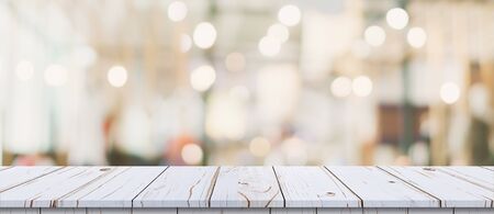 Empty wood table and blurred light table in shopping mall with bokeh background. product display template.の写真素材