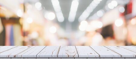 Abstract blurred image of department store with wooden table counter background for show , promote ,design on display conceptの写真素材