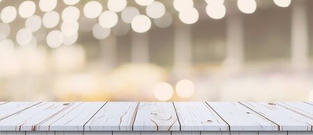 Empty wood table and blurred light table in shopping mall with bokeh background. product display template.の写真素材