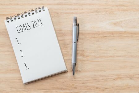 Top view of notepad with Goals List on wooden table, goals concept.の写真素材
