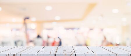 Empty wood table and blurred light table in shopping mall with bokeh background. product display template.の写真素材