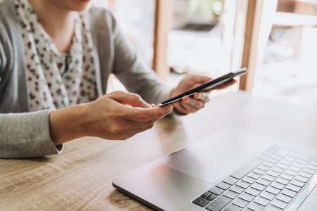 woman using smart phone and credit card for shopping online in coffee shopの写真素材