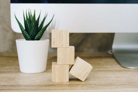 Four wooden toy cubes on wooden table background with copy spaceの写真素材