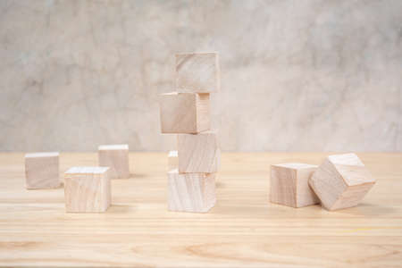Wooden toy cubes on wooden table ang grey backgroundの写真素材