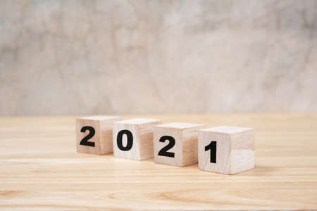 2021 happy new year on wood block on wooden table ang grey background. new year concept.の写真素材