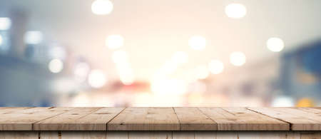 Abstract blurred image of department store with wooden table counter background for show , promote ,design on display conceptの写真素材