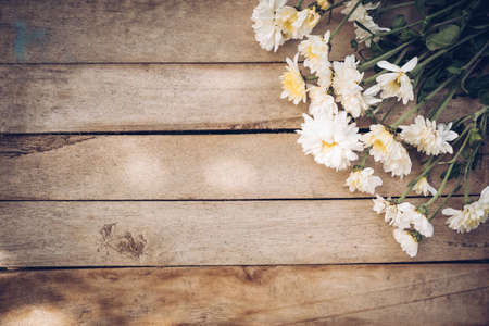Flowers on old grunge wooden table texture and background with copy space.の写真素材