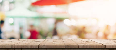 Empty wood table and blurred light table in shopping mall with bokeh background. product display template.の写真素材