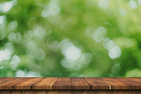 Empty wood table and green bokeh blur with copy space display montage for product.の写真素材