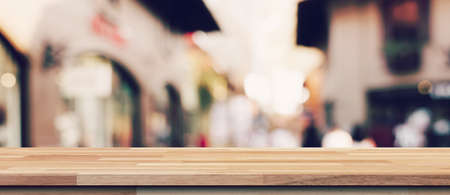 Empty wood table and blurred light table in shopping mall with bokeh background. product display template.の写真素材