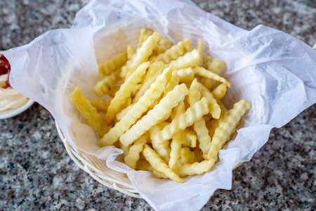 French fries in a basket with ketchupの写真素材