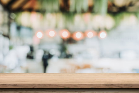 Empty wood table and blurred light table in coffee shop and cafe with bokeh background. product...