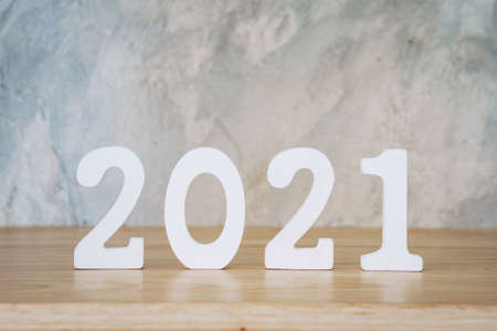 Business and design concept - wooden number 2021 for Happy new year text on wood table.の写真素材