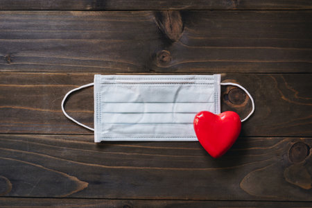 Protective face mask and red heart , Covid-19 concept.の写真素材