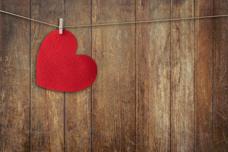 Red heart hanging on Wood Background and Texture vertical, Vintage toned.の写真素材