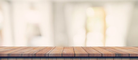 Empty wood table top on blur white window background. For product or foods montage.の写真素材